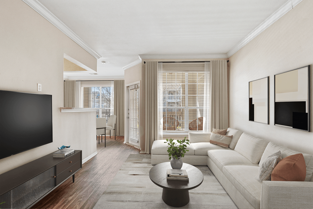 a seating area with a sofa coffee table and television