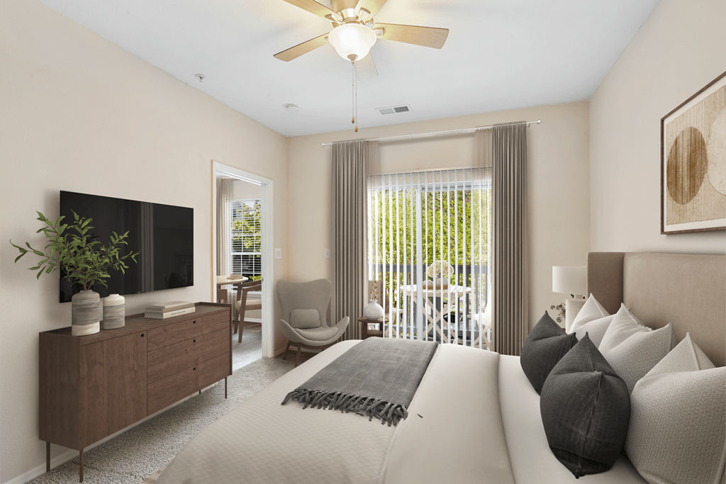 a bedroom with a large bed and a ceiling fan