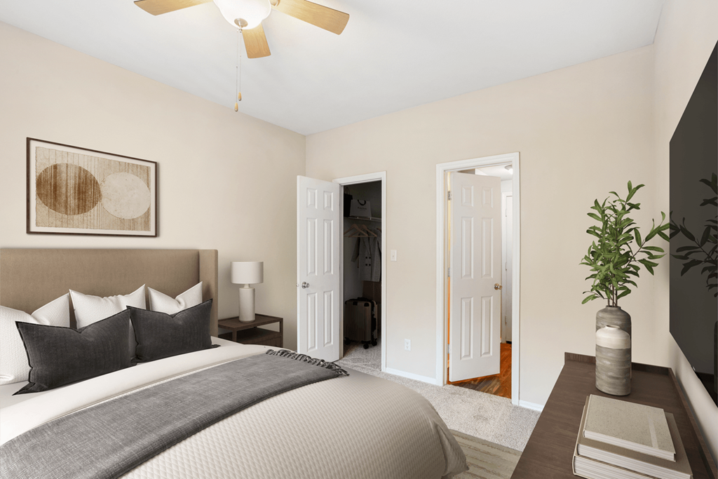 a bedroom with a large bed and a ceiling fan