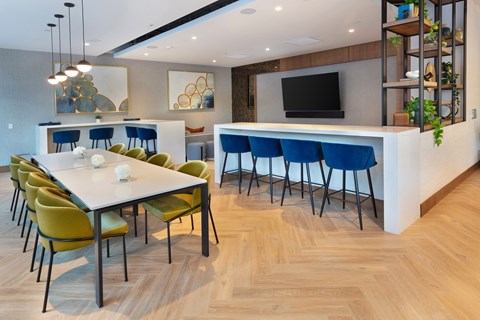 A modern dining room with a long table and chairs.