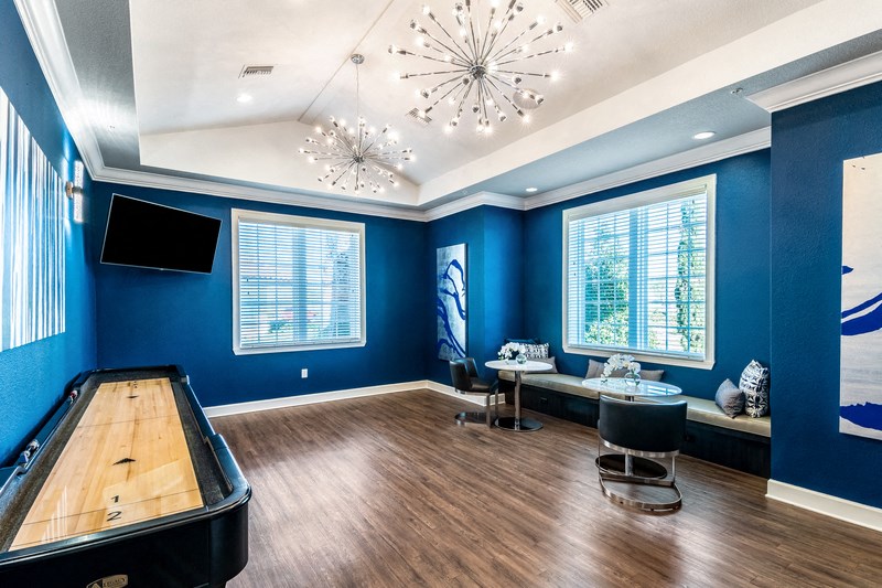 a blue game room with a pool table and a tv