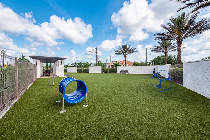 the backyard has a playground with two slides and a basketball court