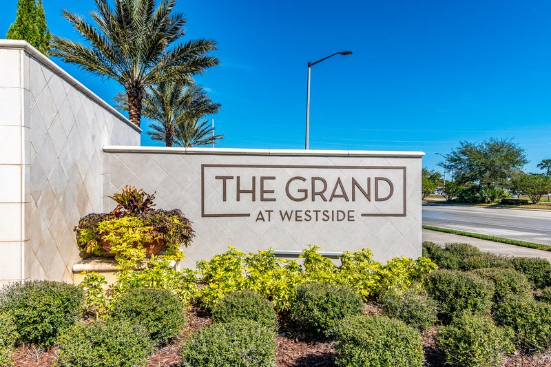 the grand at westside sign at the entrance to the community