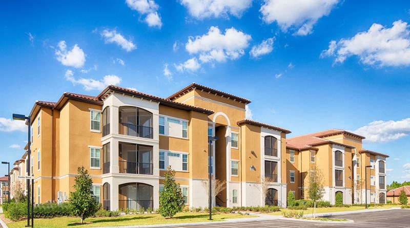 a row of apartments with a blue sky in the background