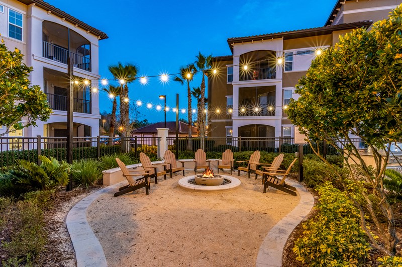 a courtyard with a fire pit at night