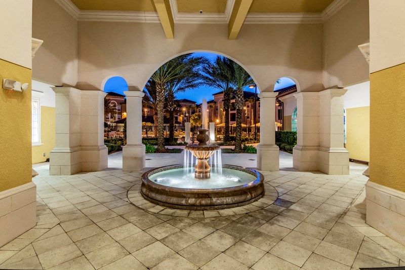 a fountain in the middle of a lobby with columns