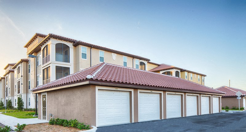 a row of garage doors in front of a house