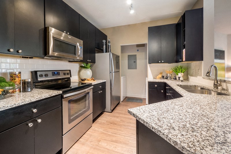 a kitchen with stainless steel appliances and granite counter tops
