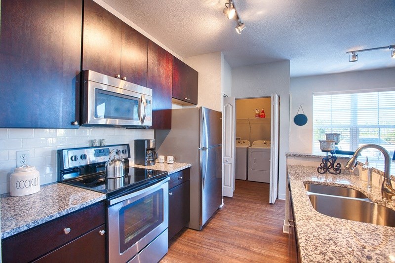 a kitchen with stainless steel appliances and granite counter tops