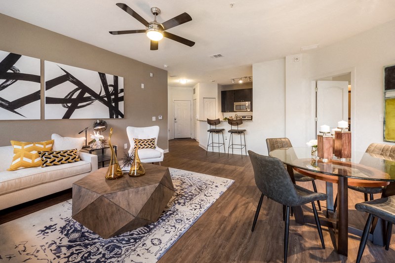 a living room and dining room with a table and a couch