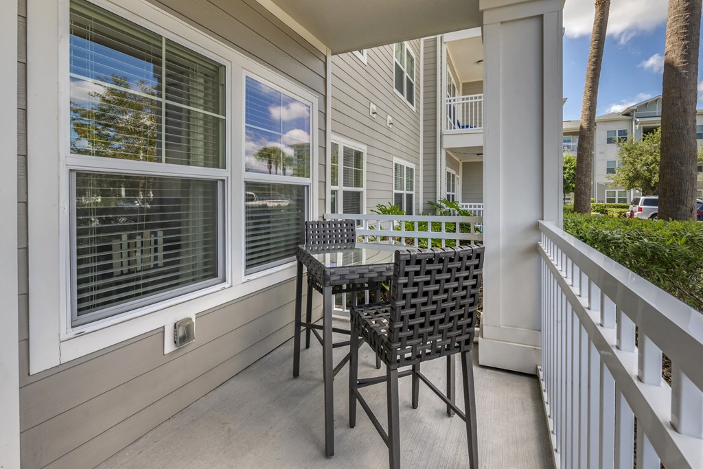 a patio with a table and chairs on a balcony