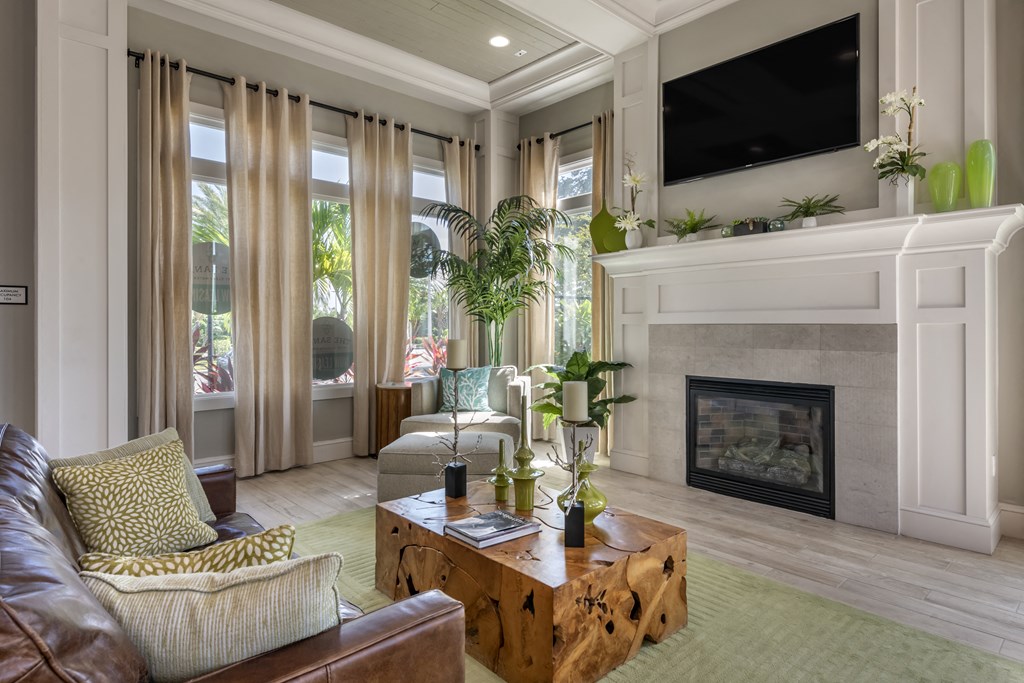 a living room with a fireplace and a couch and a table