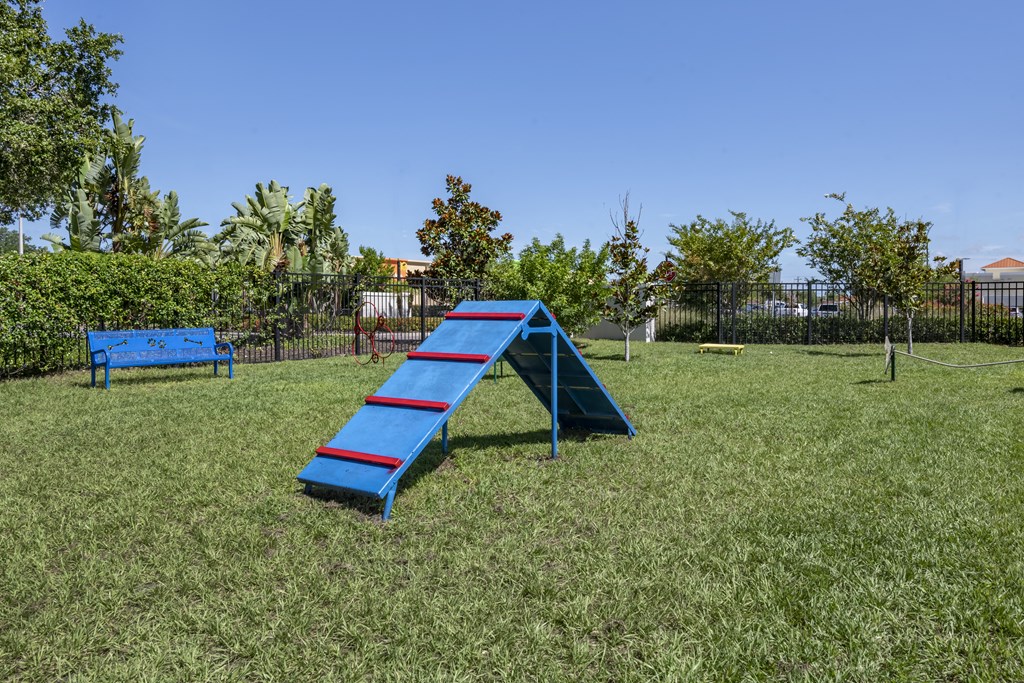 a blue slide and a blue bench in a park