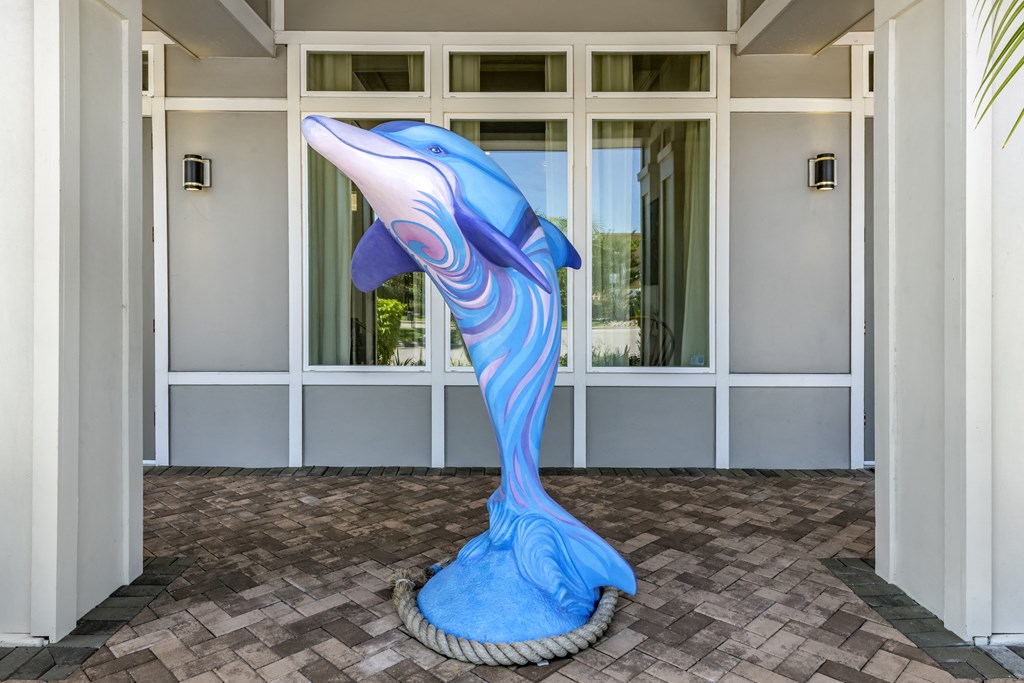 a statue of a dolphin in front of a building