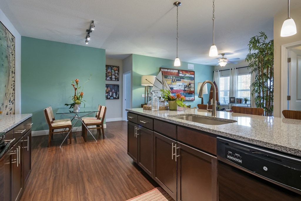 a kitchen with an island and a dining room with a table