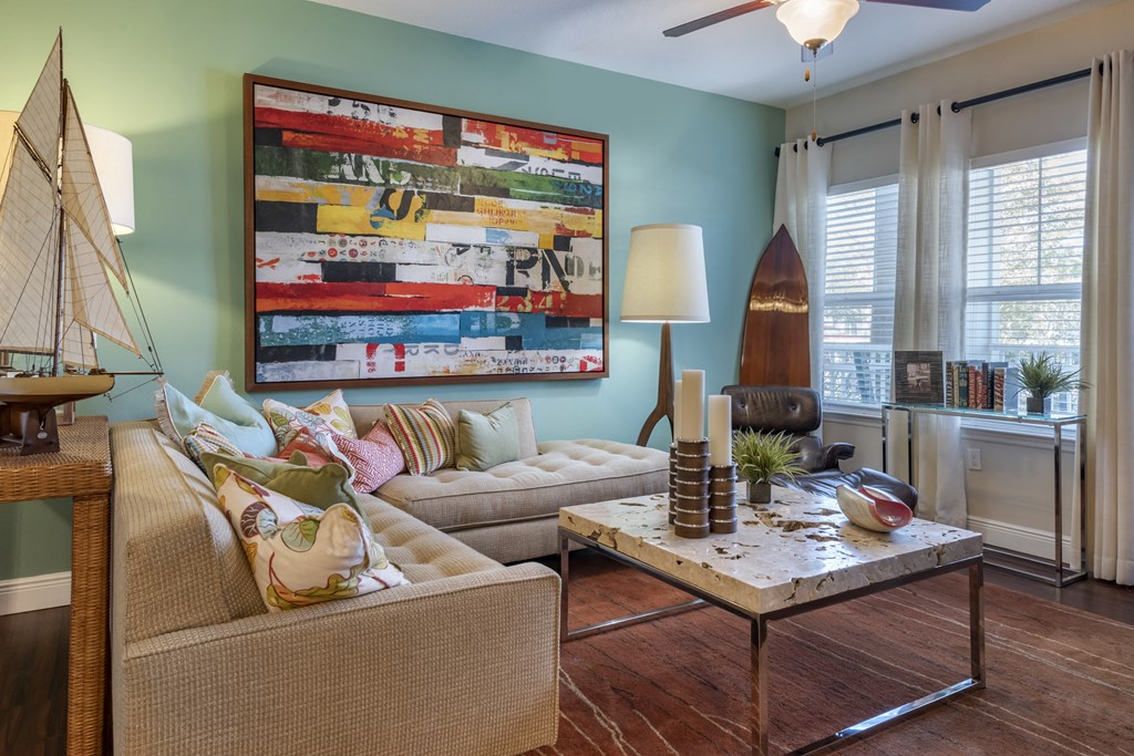 a living room with a couch and a coffee table and a surfboard