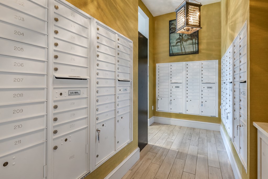 a locker room with rows of white lockers and wooden floors