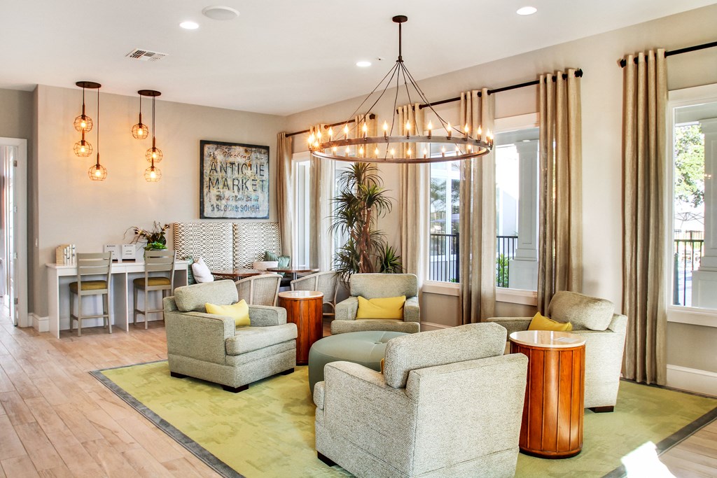 a living room and dining room with chairs and a chandelier