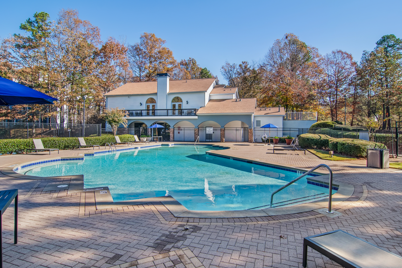 a resort style pool with a building in the background
