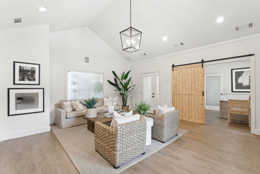 the living room of a new home with a sliding barn door