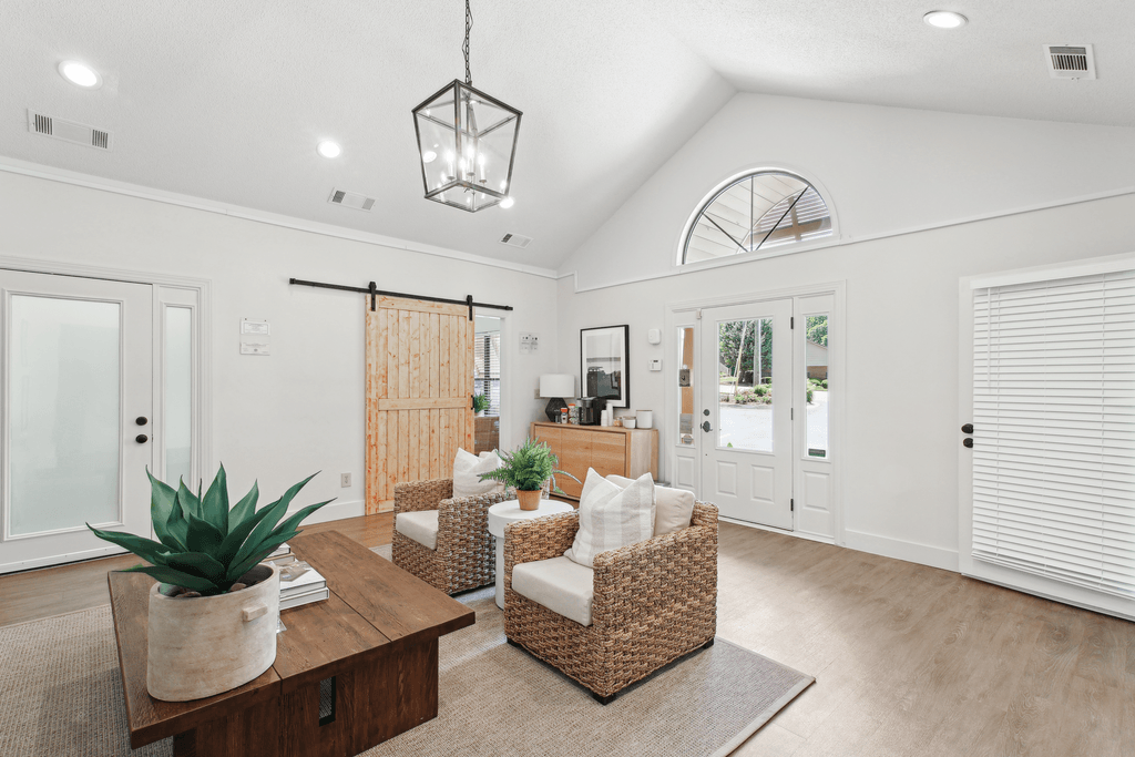 the living room of a new home with white walls and a wooden table and chairs