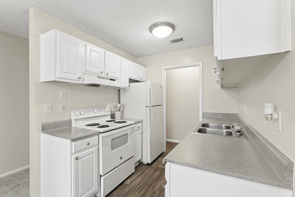 a kitchen with white appliances and white cabinets