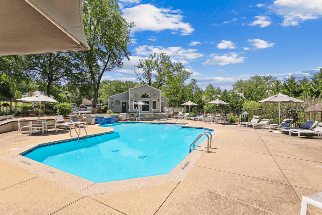 a swimming pool with chairs and umbrellas at the resort