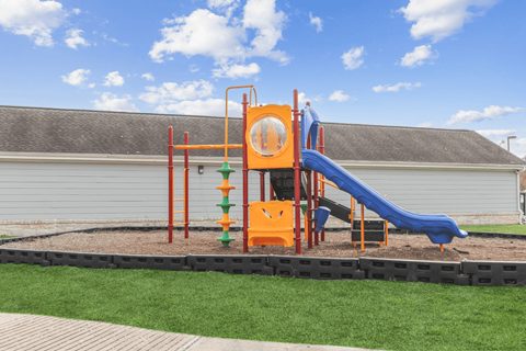 A playground with a blue slide and orange play structure.