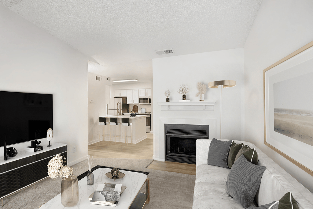 Virtually staged livingroom with carpet, couch with pillows, coffee table, wall mounted television with tv stand and fireplace with mantel