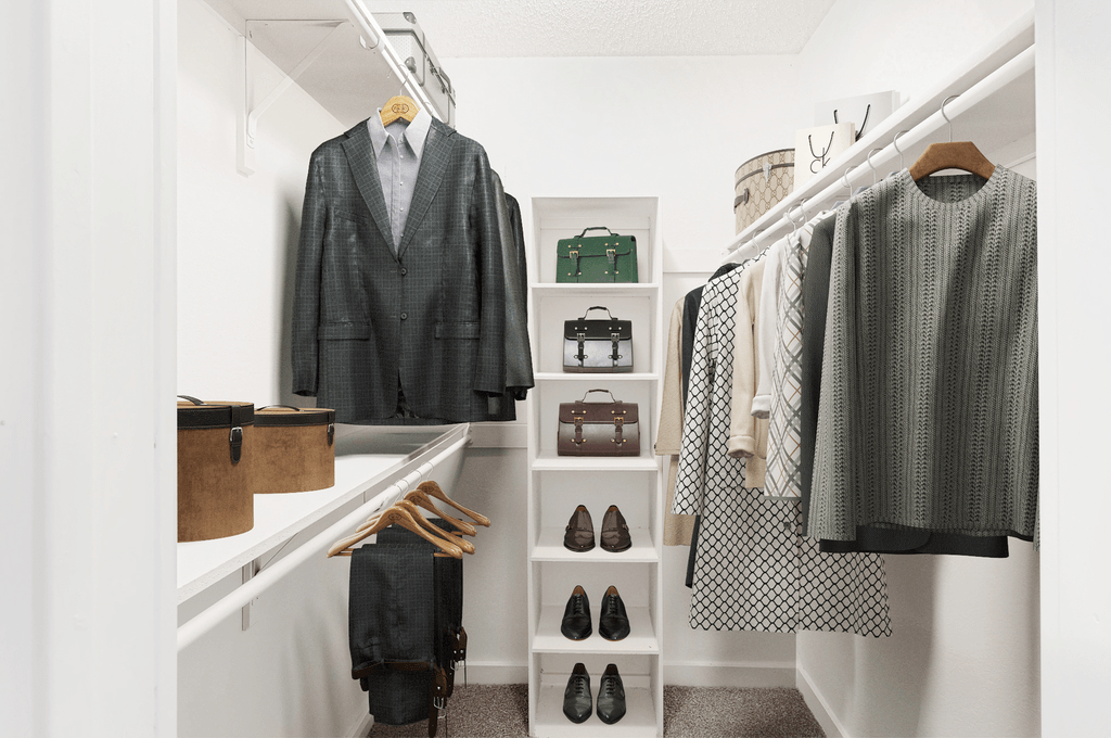 Virtually staged walk in closet with hanged clothes, shelves, shoes and handbags