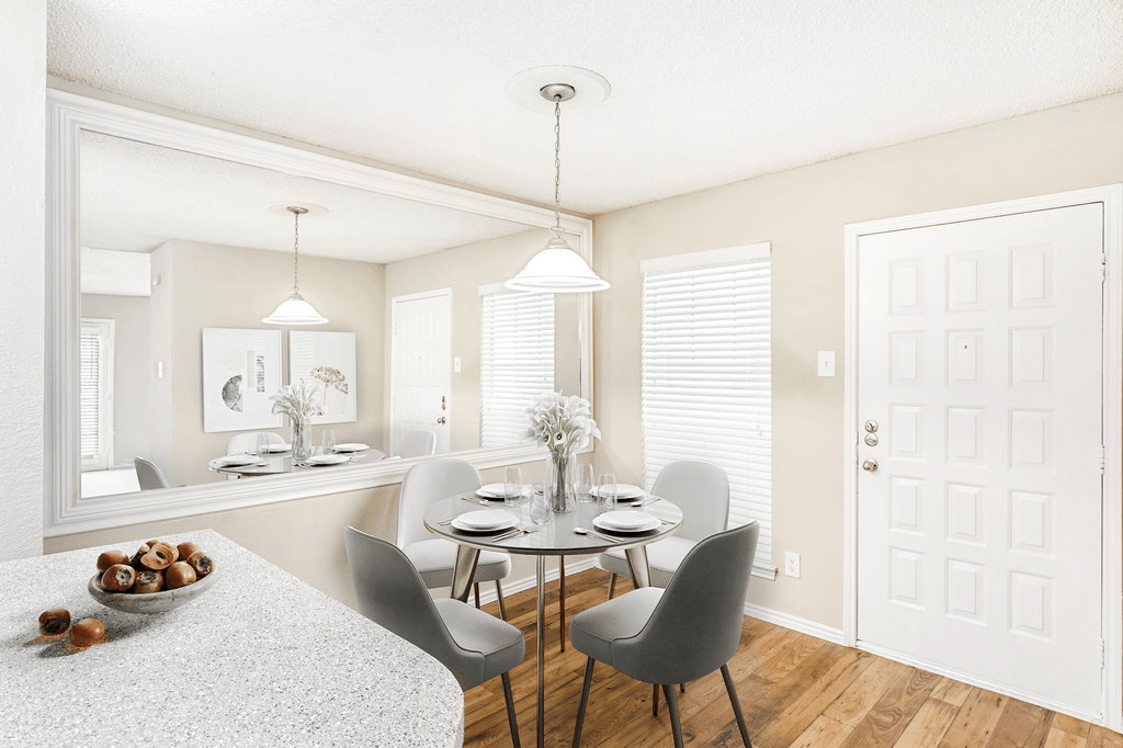 Virtually staged dining room with round table, chairs