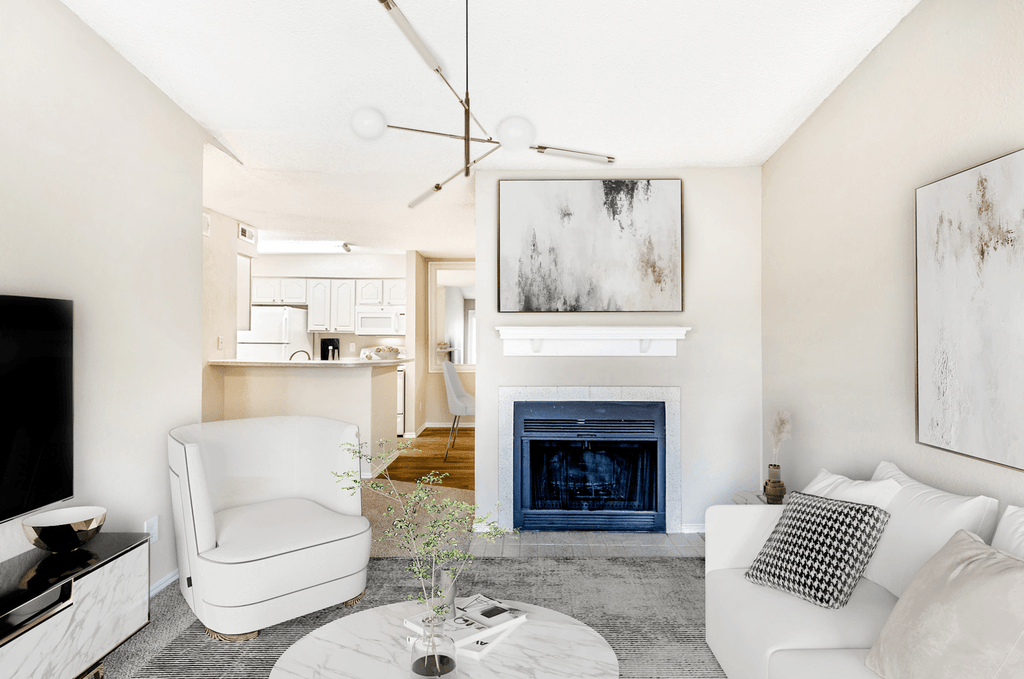 Virtually staged livingroom with carpet, accent rug, white couch and chairs, fireplace with mantel and tv stand with large flat screen television