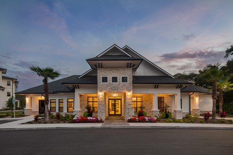 a rendering of a house with lights on and a street in front of it