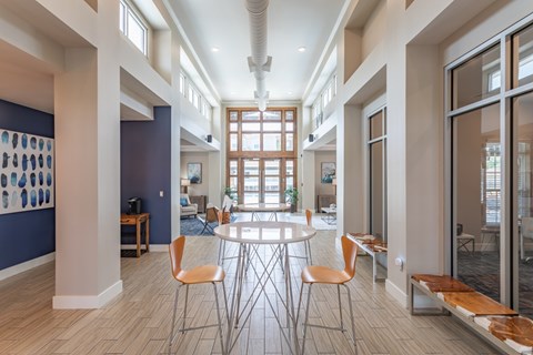 A modern dining room with a round table and chairs.