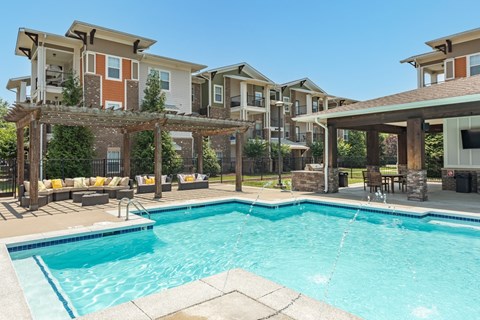 A swimming pool in front of apartment buildings.