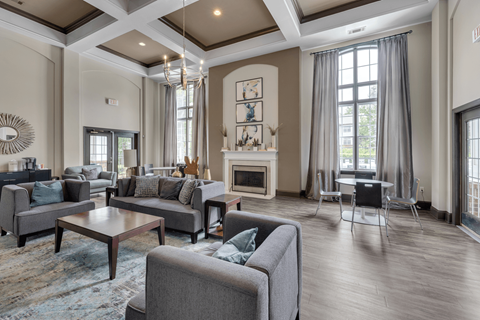A living room with a grey couch and a fireplace.