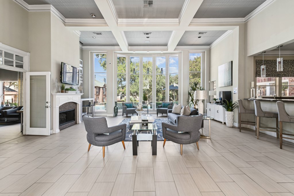 A living room with a fireplace and a large window.