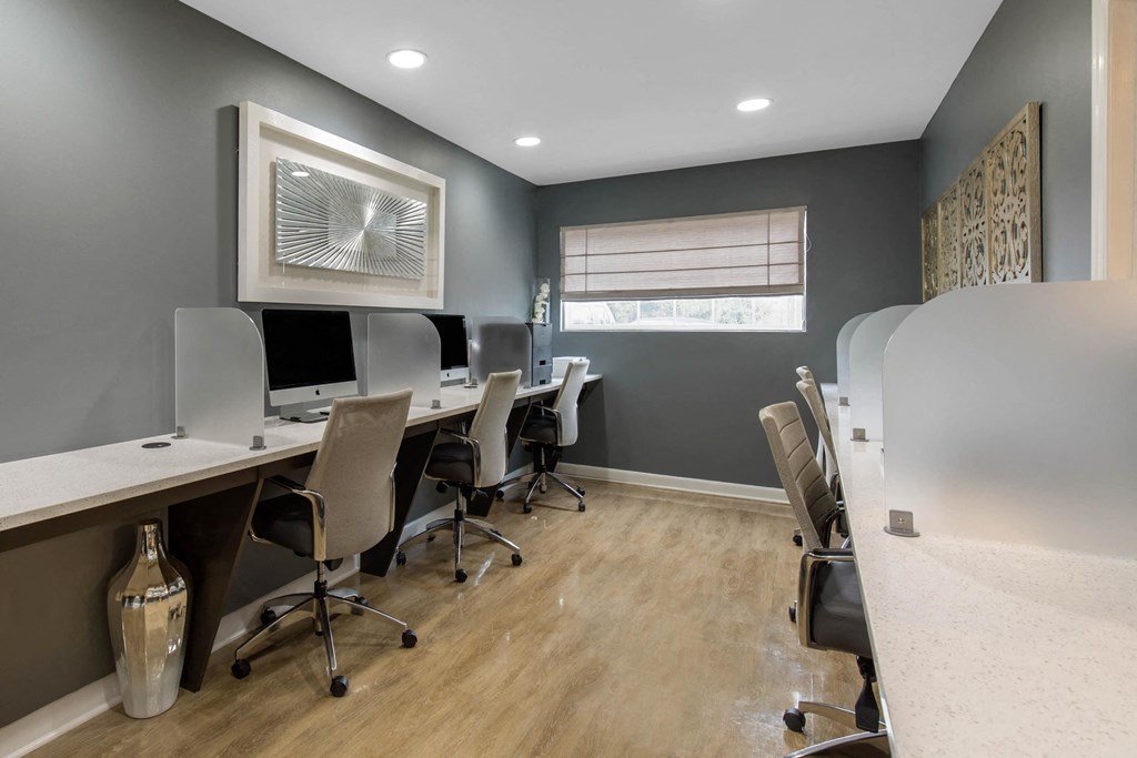 Business center with four workstations with computers and a printer