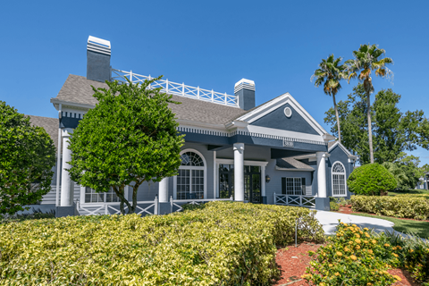 Exterior of leasing office with lush landscaping.