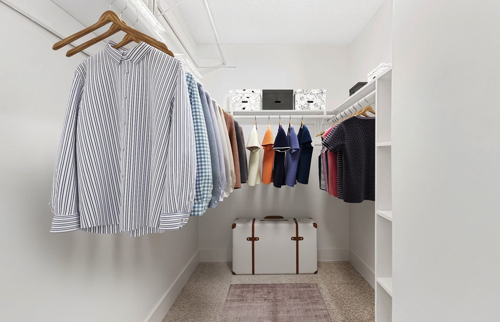 A white closet with clothes at Woodlyn on the Green Apartment Homes, Cary, 27513