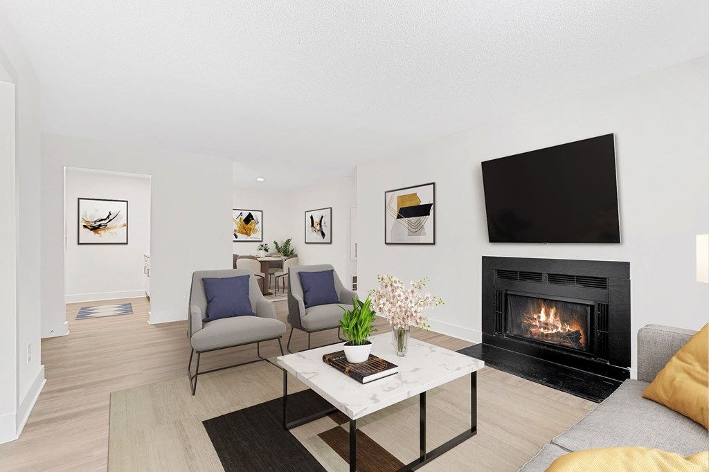 A living room with a fireplace and a television. at Woodlyn on the Green Apartment Homes, Cary, NC, 27513