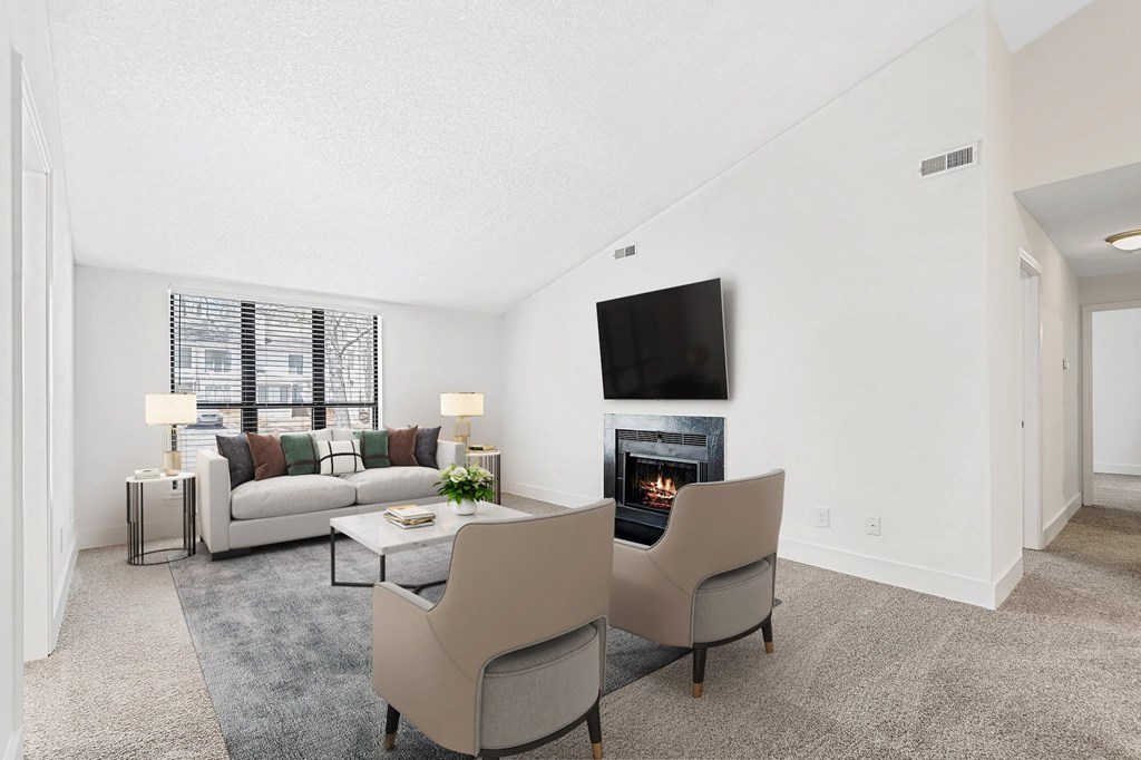 A living room with a fireplace and a television. at Woodlyn on the Green Apartment Homes, North Carolina