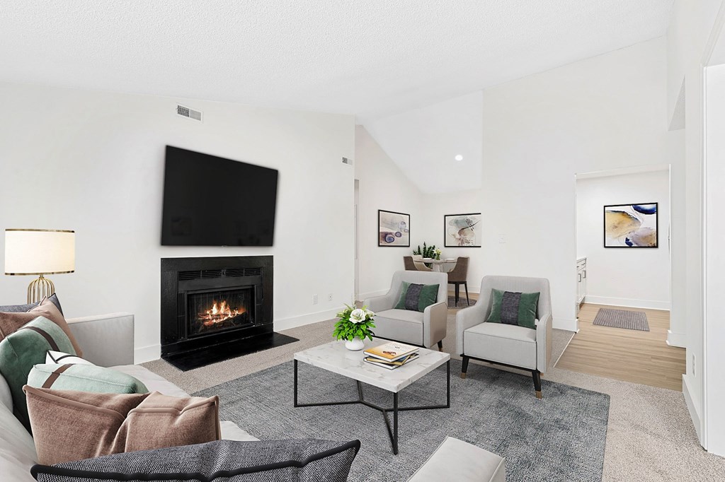 A living room with a fireplace and a couch. at Woodlyn on the Green Apartment Homes, Cary, North Carolina