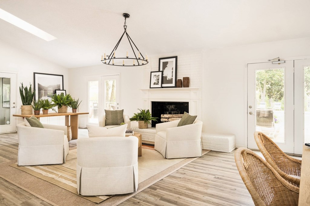 A living room with a fireplace and a chair. at Woodlyn on the Green Apartment Homes, Cary, North Carolina