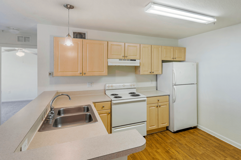 A kitchen with wooden cabinets and white appliances.