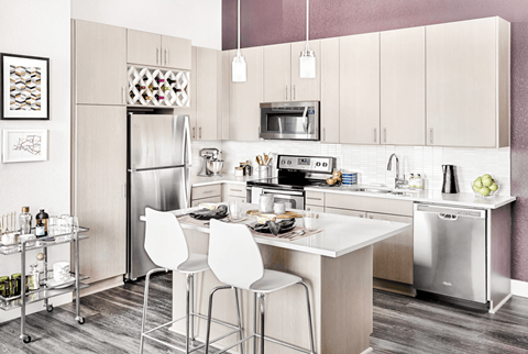 A modern kitchen with a white table and chairs.