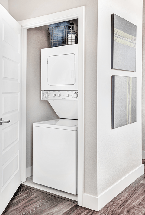 A white built in dishwasher and oven in a kitchen.