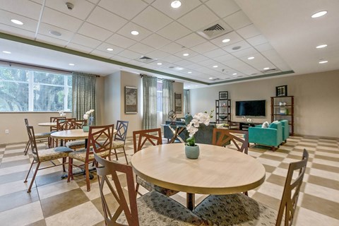A dining room with a round table and chairs.