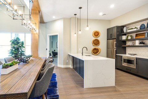 A modern kitchen with a wooden table and chairs.