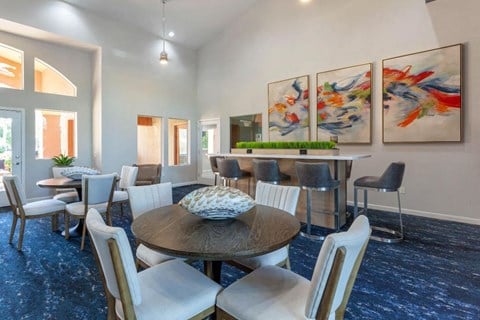 A dining room with a round table and chairs.